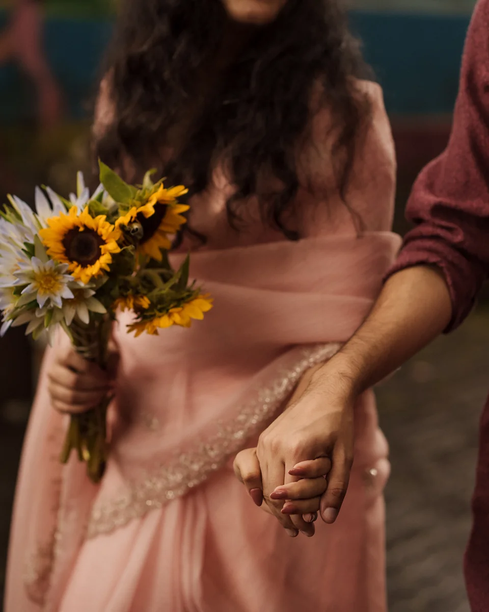 Holding hands, sunflowers in hand